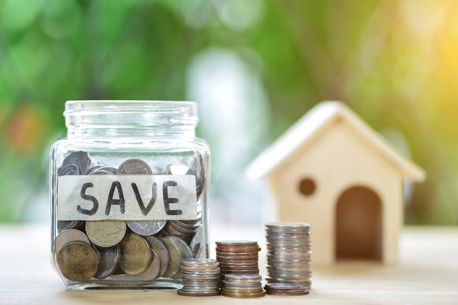 A mason jar full of coins represents money saved on moving cost